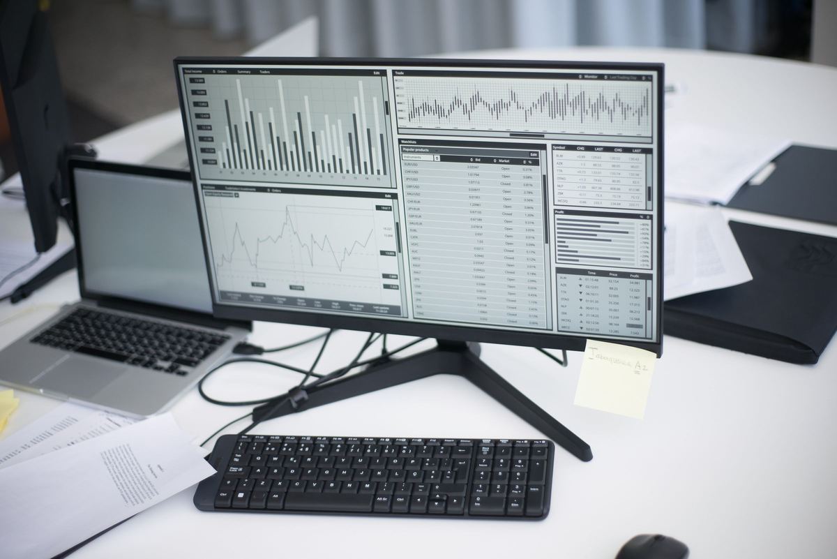Analytics dashboards on a desktop monitor and laptop