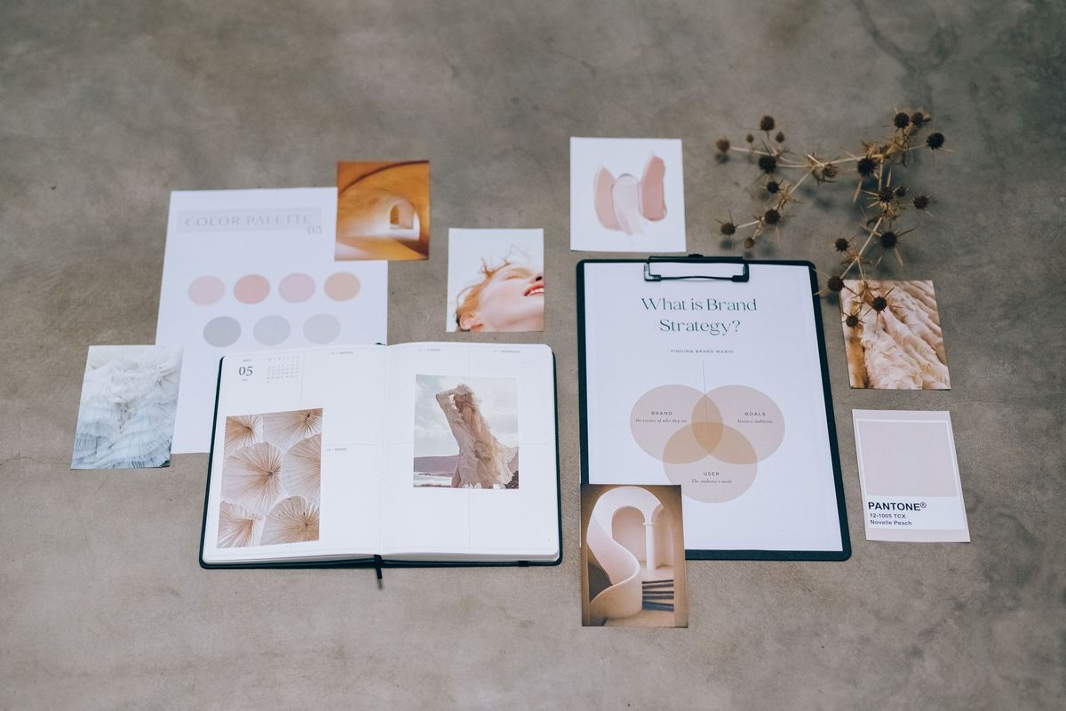 Brand strategy documents, color palettes and design concepts on a desk