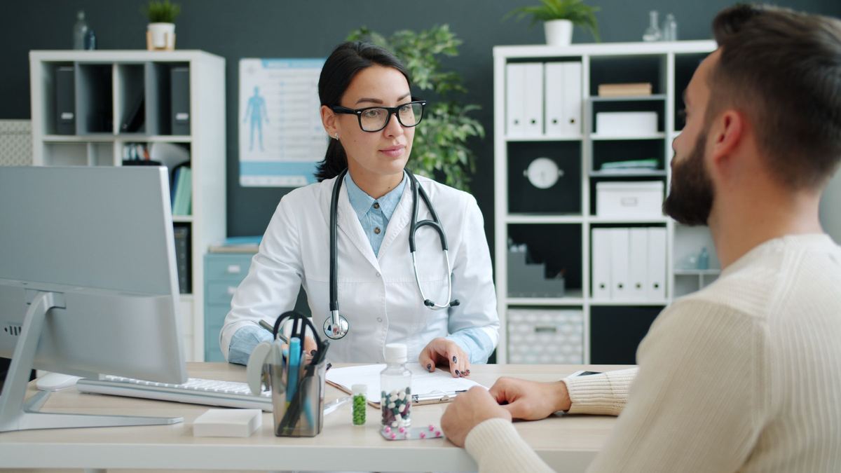 Physician discussing a plan with a patient in a modern clinic