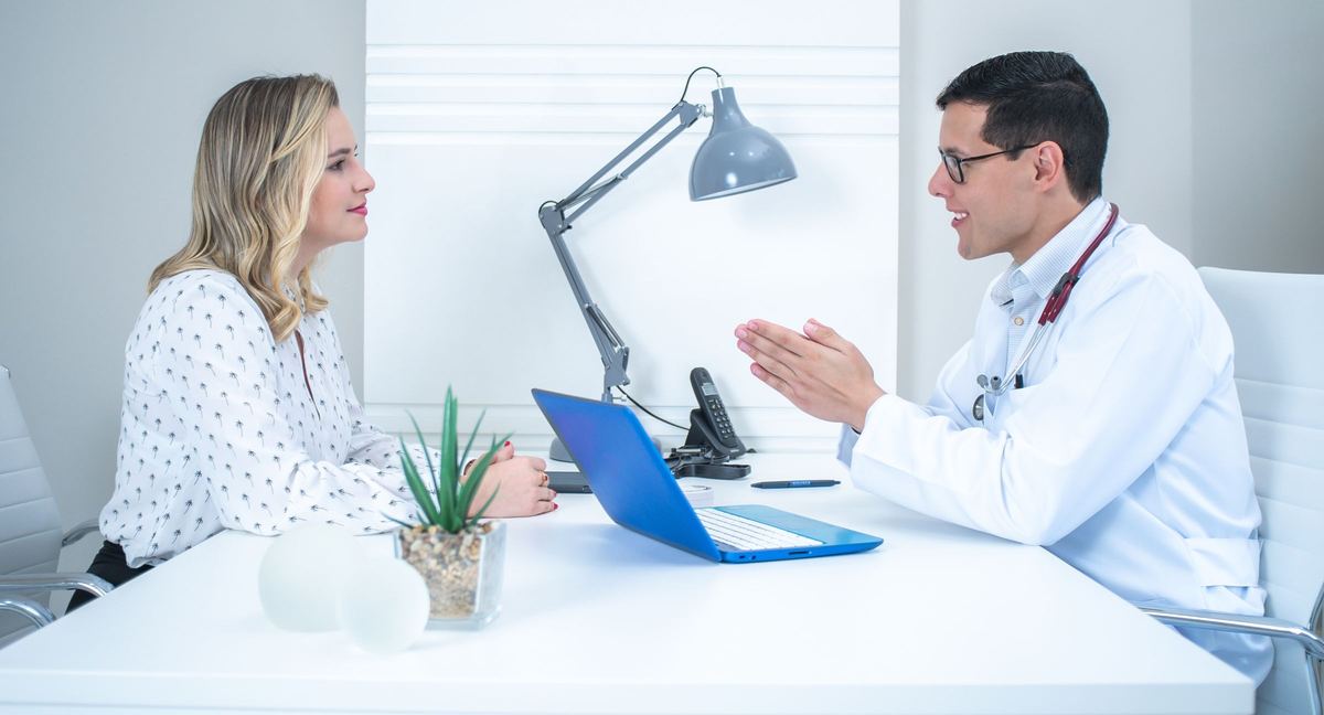 Physician explaining next steps to a patient in a bright office