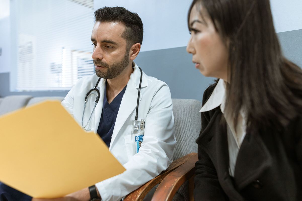 Physician reviewing a patient folder during a consultation