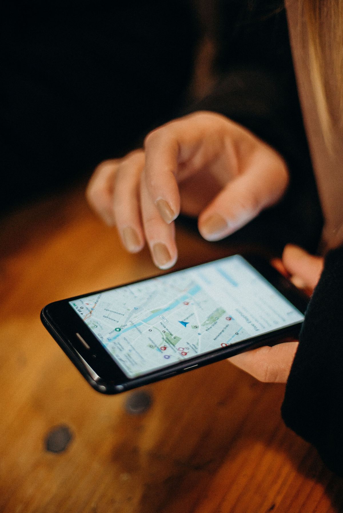 Person searching a map on a smartphone to find a nearby location