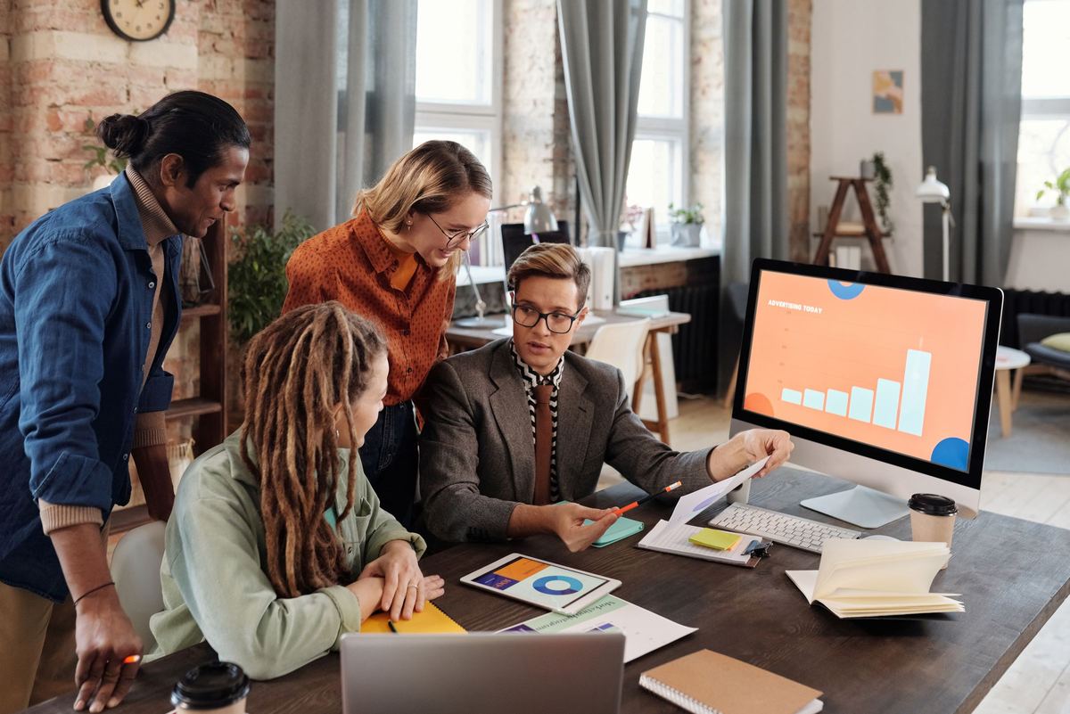 Marketing team reviewing a growth plan around a desk