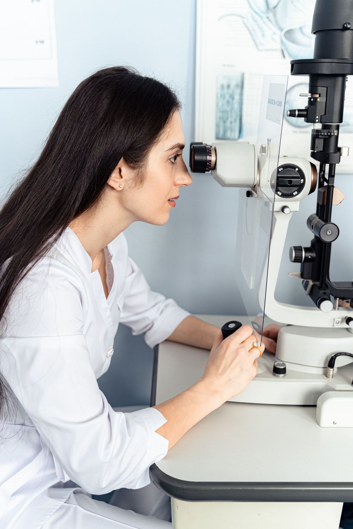 Eye doctor using a slit lamp in an ophthalmology clinic