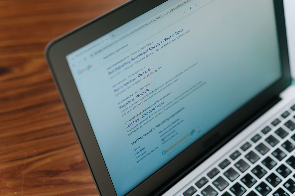 Laptop displaying search engine results on a desk